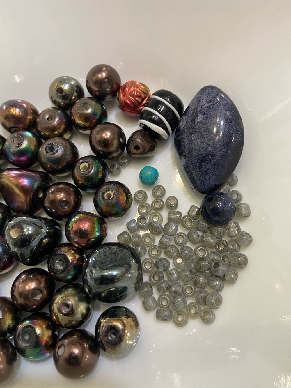 A mix of beads. Small grey seed beads and larger random beads.